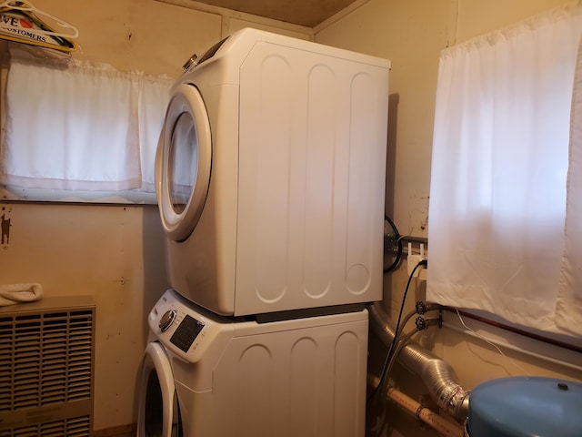 clothes washing area featuring stacked washer / drying machine