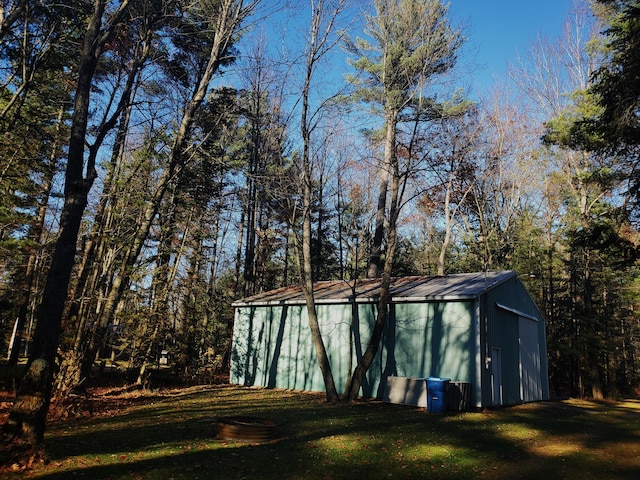 view of outbuilding with a lawn