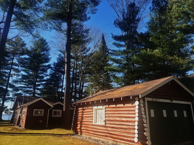 view of property exterior featuring an outbuilding and a garage