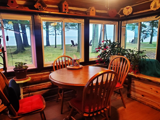 sunroom / solarium with a water view and a healthy amount of sunlight