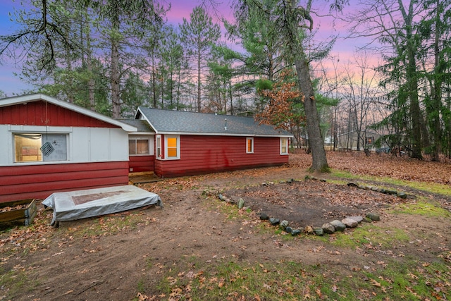 view of back house at dusk