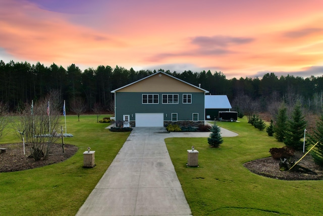 view of front of home with a lawn and a garage