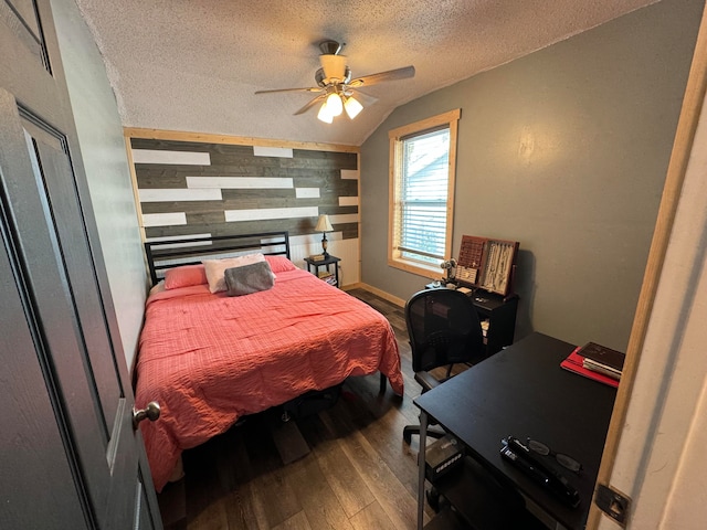 bedroom with a textured ceiling, hardwood / wood-style flooring, ceiling fan, and lofted ceiling