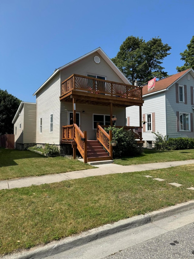 view of front facade featuring a front lawn and a deck