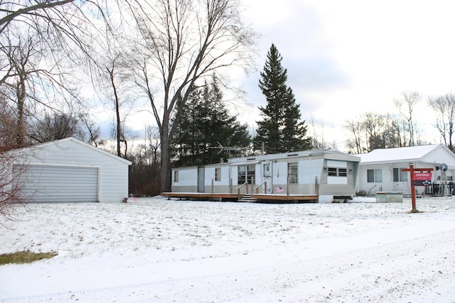 view of front facade featuring a deck, central AC unit, an outdoor structure, and a garage