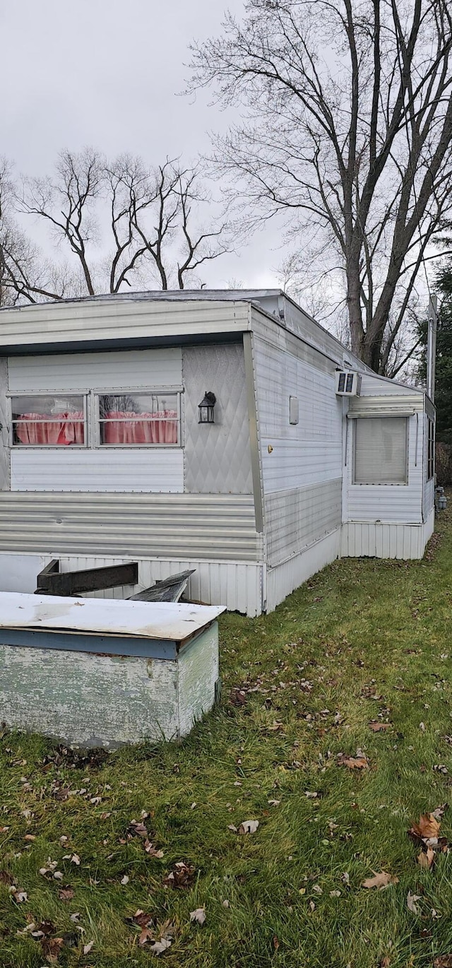 view of side of home featuring a yard