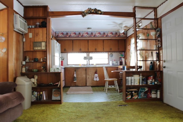 kitchen featuring carpet floors, white refrigerator, a wall unit AC, and ceiling fan