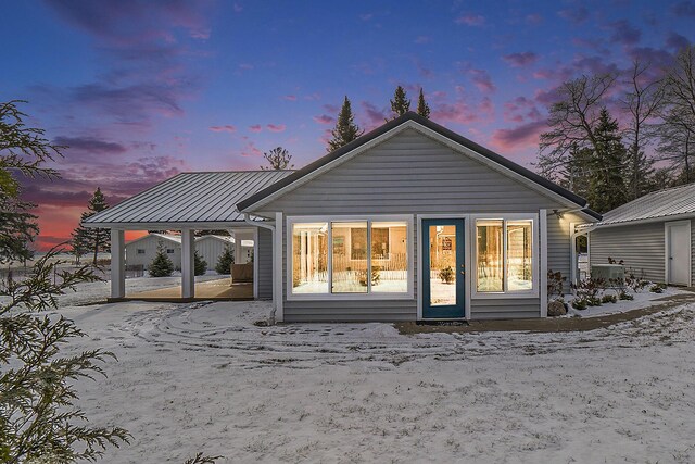 view of snow covered back of property