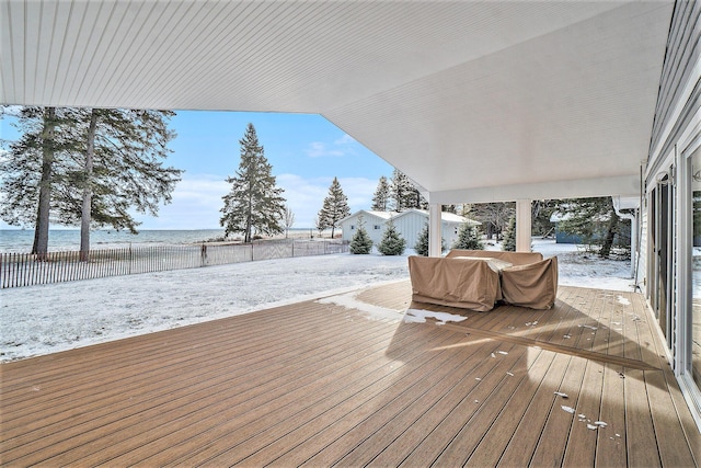 snow covered deck featuring a water view