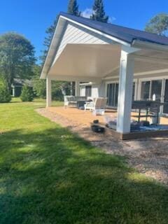 rear view of property with a yard and a patio area