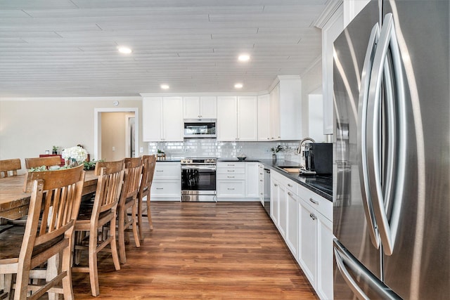 kitchen featuring white cabinetry, ornamental molding, stainless steel appliances, and sink