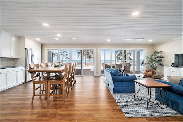 dining area featuring hardwood / wood-style flooring and ornamental molding