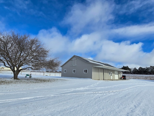 view of snowy exterior featuring an outdoor structure