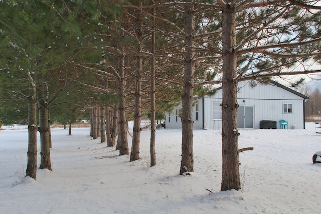 yard layered in snow with an outdoor structure