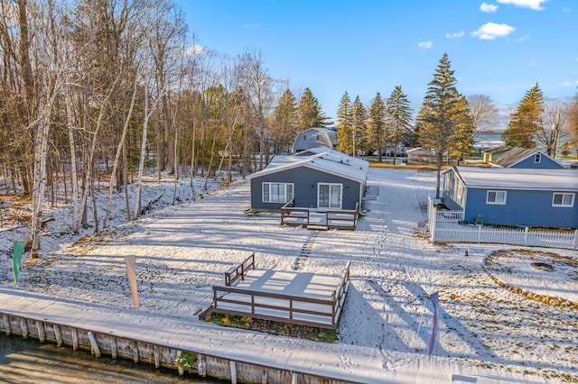 view of snow covered rear of property