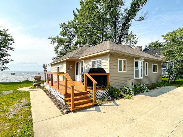 view of front of house featuring a deck with water view