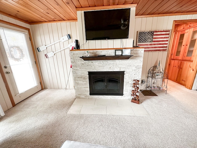 interior details with carpet flooring, a stone fireplace, wood walls, and wood ceiling