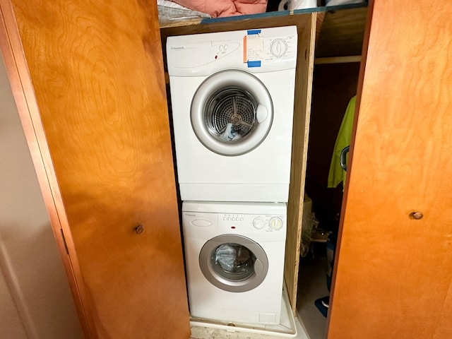 laundry area with stacked washing maching and dryer