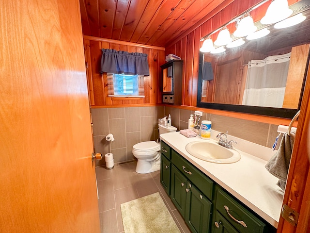 bathroom featuring vanity, wooden walls, tile patterned flooring, toilet, and wood ceiling