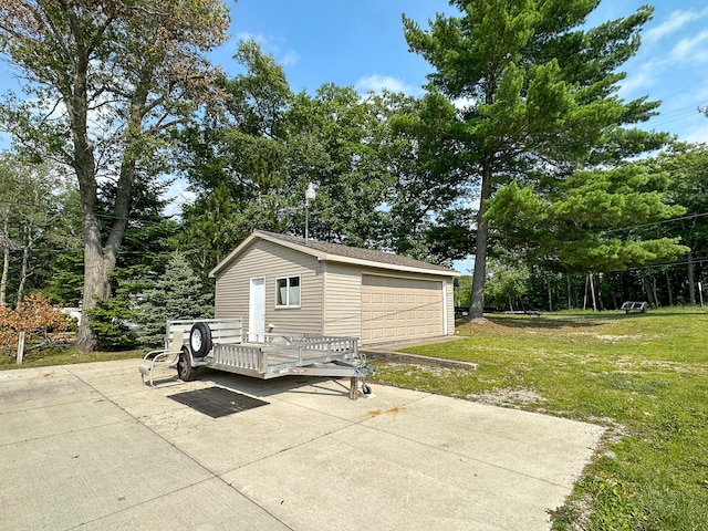 view of outdoor structure with a yard and a garage