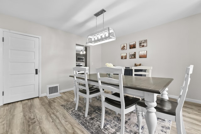 dining area with light hardwood / wood-style flooring