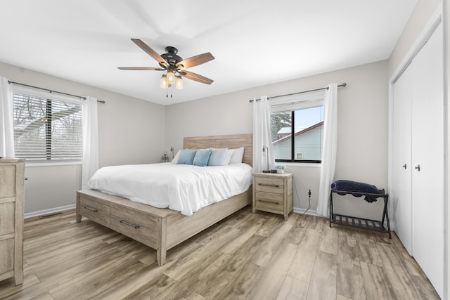 bedroom with ceiling fan, wood-type flooring, and a closet