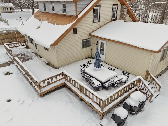 view of snow covered rear of property