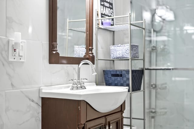 bathroom featuring vanity, decorative backsplash, and tile walls