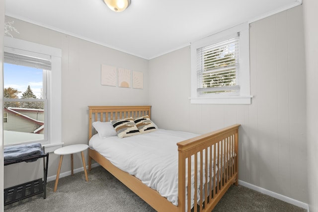 bedroom with dark colored carpet and crown molding