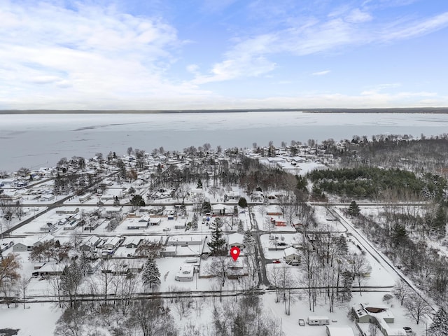 snowy aerial view featuring a water view