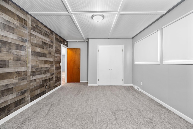 interior space with wooden walls and carpet