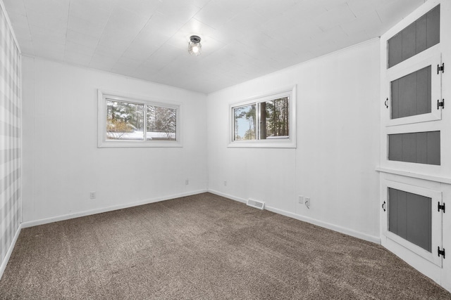 carpeted spare room with crown molding