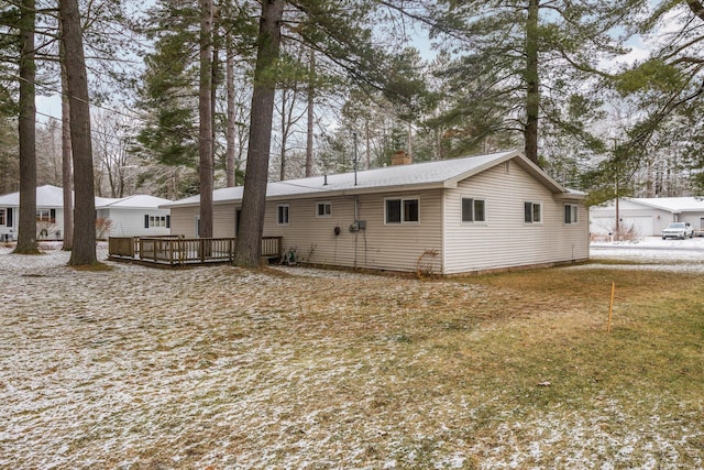 snow covered property featuring a wooden deck