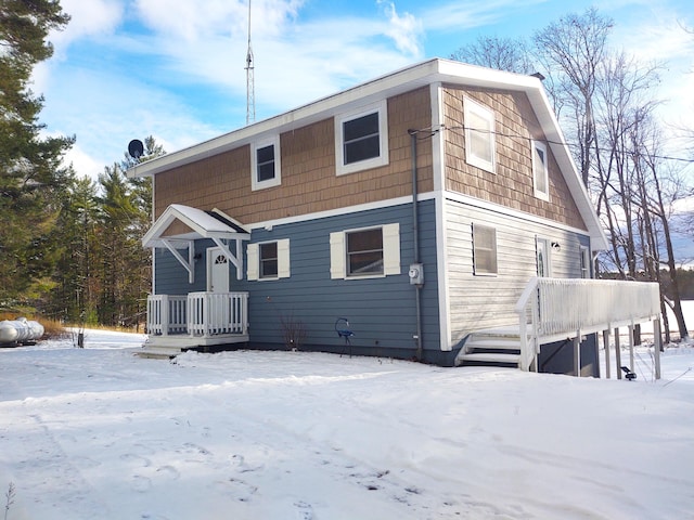 view of snow covered back of property