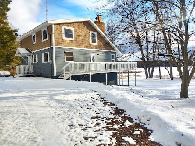 snow covered property featuring a deck