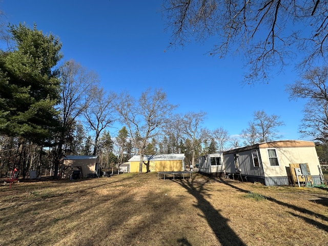 view of yard with a storage unit and a trampoline