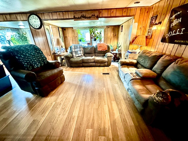 living room with wood walls and wood-type flooring