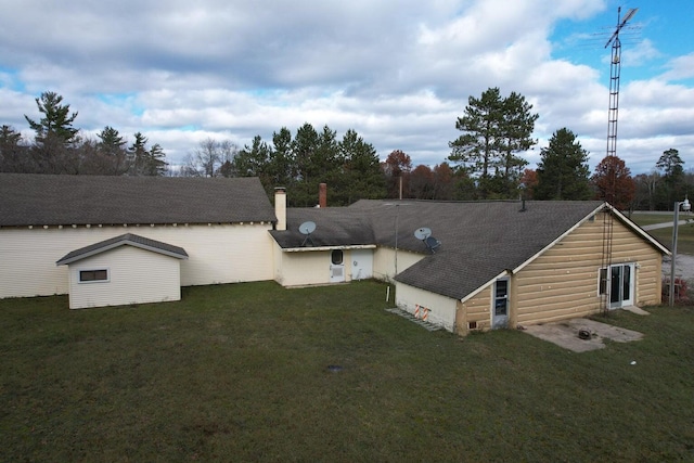 back of property featuring a lawn