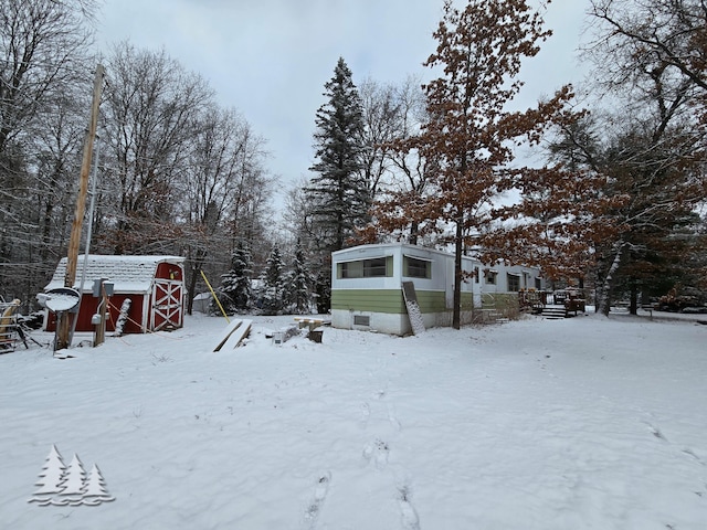 snowy yard with an outdoor structure