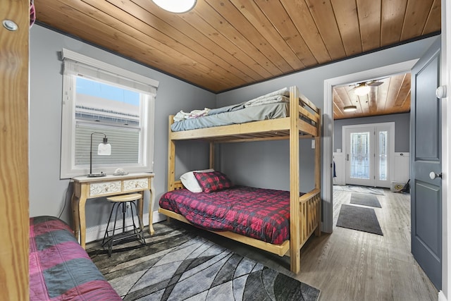 bedroom with wooden ceiling and hardwood / wood-style flooring