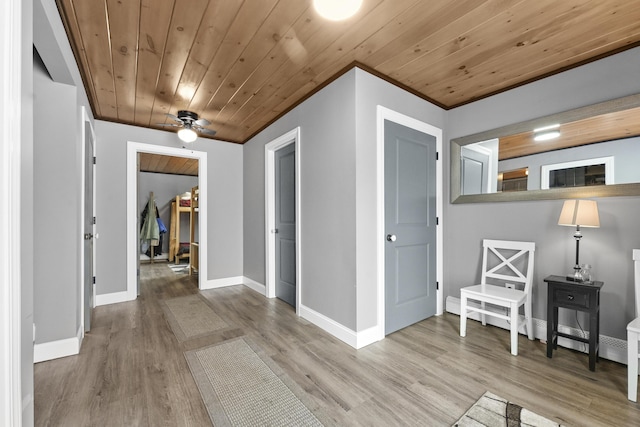 corridor with wooden ceiling and light hardwood / wood-style flooring