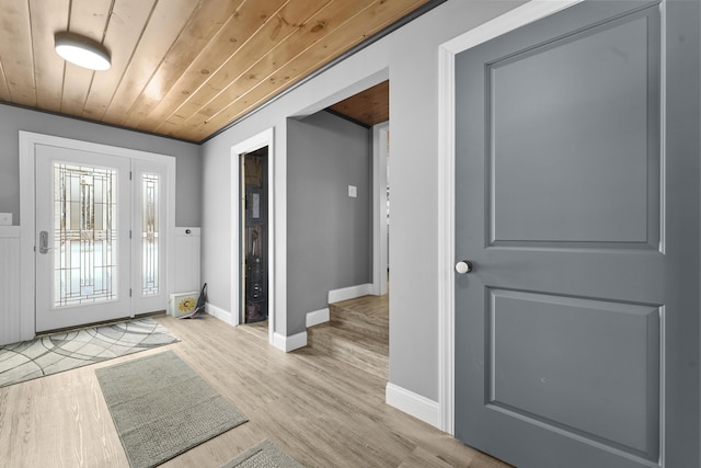 doorway with light hardwood / wood-style floors and wooden ceiling