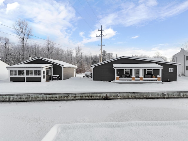 view of snow covered rear of property