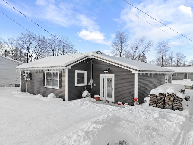 view of snow covered back of property