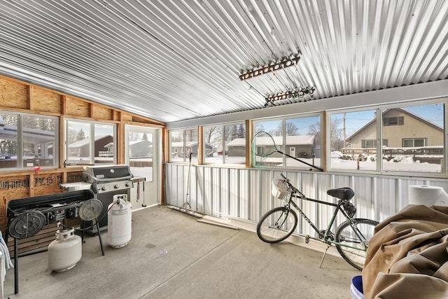 sunroom featuring vaulted ceiling