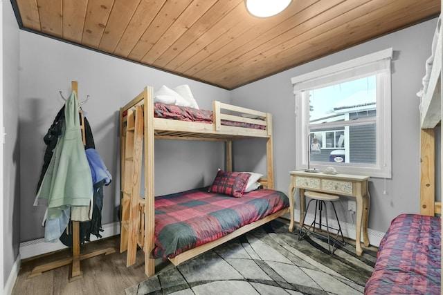 bedroom with hardwood / wood-style flooring and wooden ceiling