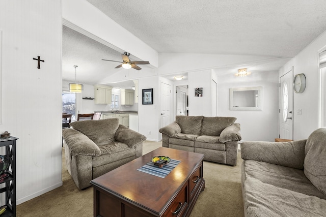 living room with a textured ceiling, light colored carpet, ceiling fan, and lofted ceiling