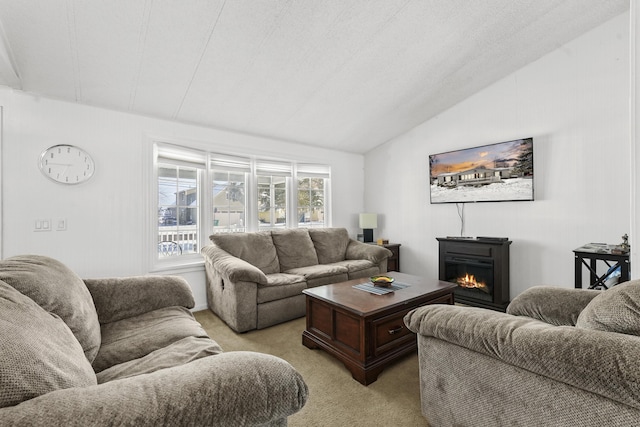 carpeted living room with a textured ceiling and vaulted ceiling