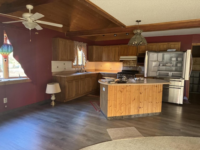 kitchen with a wealth of natural light, a kitchen island, decorative light fixtures, and stainless steel range with gas stovetop