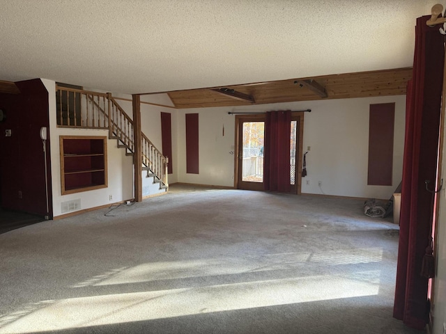 foyer with carpet and a textured ceiling